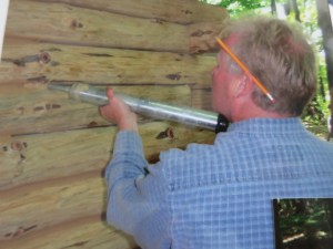 Greg chinking the cabin.